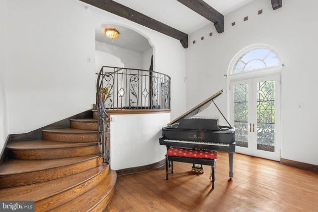 8300 Cedar Rd, Elkins Park, PA 19027 - interior space featuring beam ceiling, baseboards, arched walkways, french doors, and hardwood / wood-style flooring