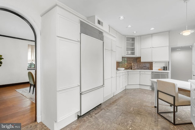 8300 Cedar Rd, Elkins Park, PA 19027 - kitchen with white cabinets, glass insert cabinets, visible vents, paneled built in fridge, and backsplash