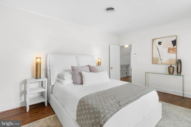 8300 Cedar Rd, Elkins Park, PA 19027 - bedroom featuring wood finished floors, crown molding, visible vents, and baseboards