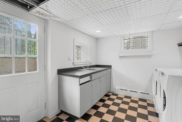 8300 Cedar Rd, Elkins Park, PA 19027 - clothes washing area featuring washing machine and dryer, a sink, a baseboard heating unit, cabinet space, and tile patterned floors