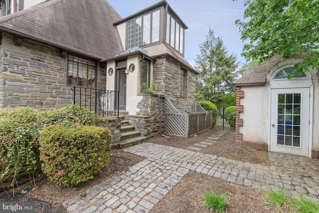 8300 Cedar Rd, Elkins Park, PA 19027 - doorway to property featuring stucco siding and stone siding