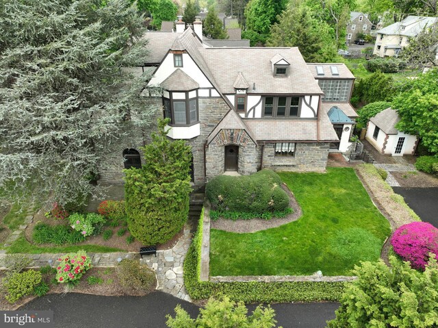 8300 Cedar Rd, Elkins Park, PA 19027 - view of front of house with a chimney, a front lawn, and stone siding