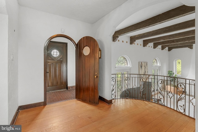 8300 Cedar Rd, Elkins Park, PA 19027 - hall with a wealth of natural light, hardwood / wood-style floors, and beamed ceiling