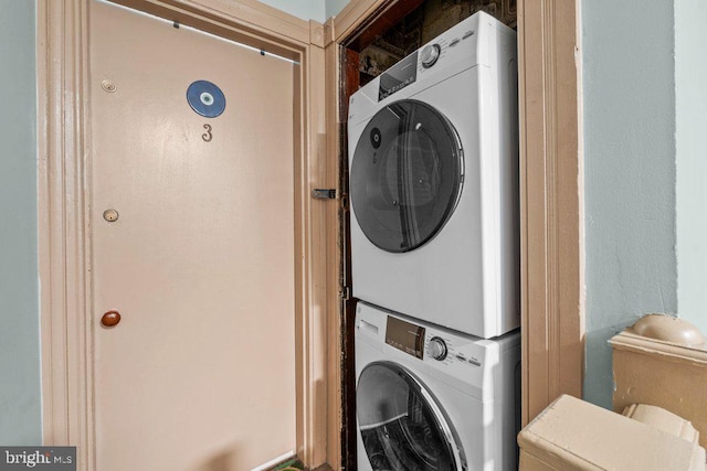 clothes washing area with stacked washer / drying machine and laundry area
