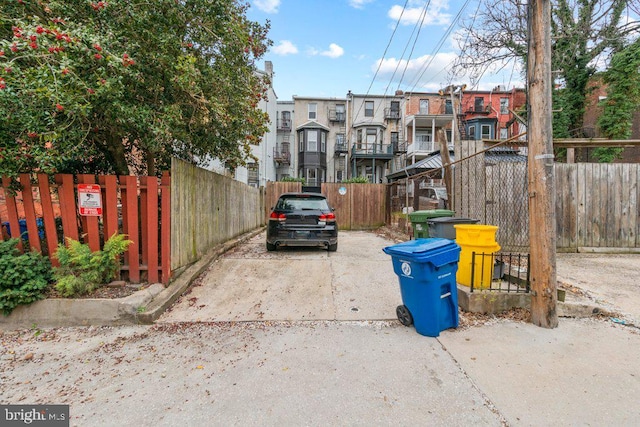 view of parking with fence