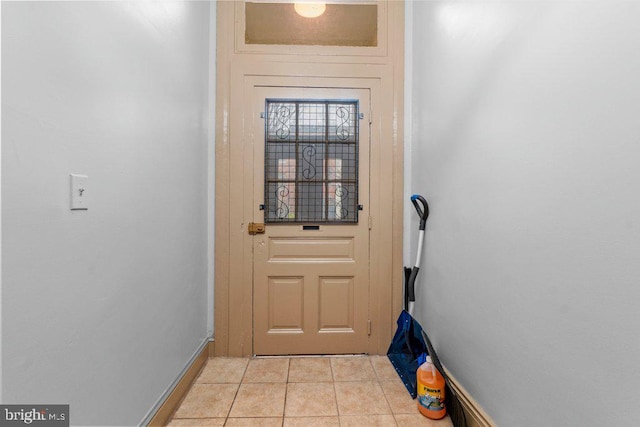 entryway featuring baseboards and light tile patterned floors