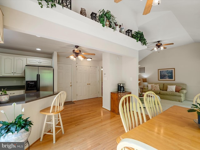 dining room featuring ceiling fan, light wood-style floors, lofted ceiling, and recessed lighting