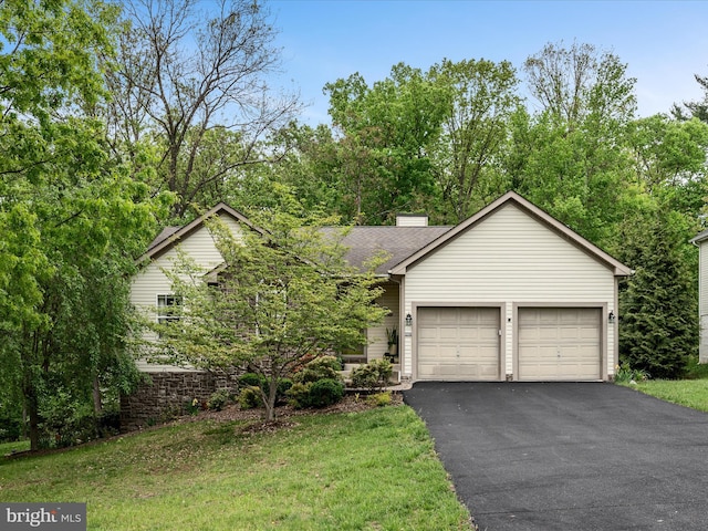 view of front facade with a garage, driveway, a chimney, and a shingled roof