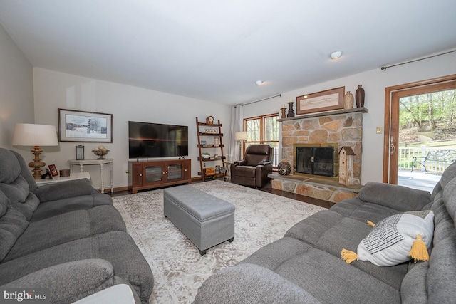 living room with a stone fireplace
