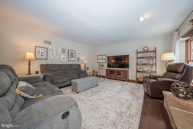 living room featuring wood finished floors and visible vents