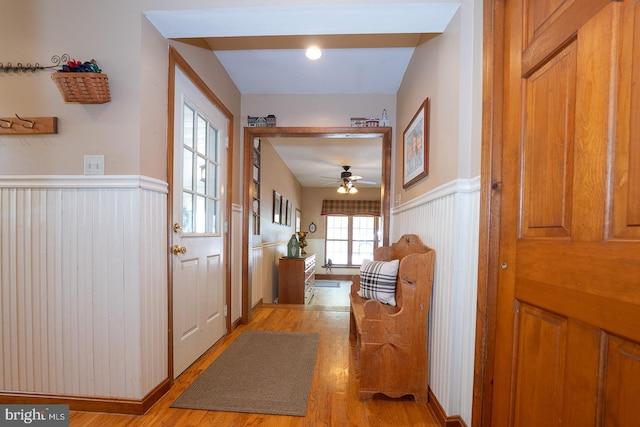 hallway with wainscoting and light wood-type flooring