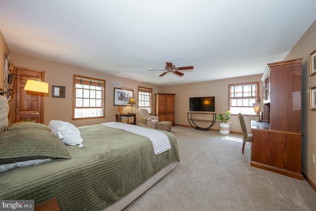 bedroom featuring a ceiling fan, baseboards, and light colored carpet