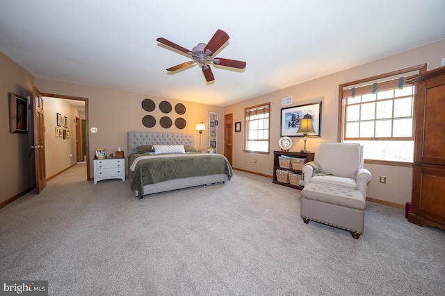 bedroom with baseboards, visible vents, a ceiling fan, and light colored carpet