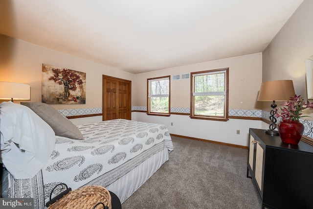 carpeted bedroom featuring baseboards