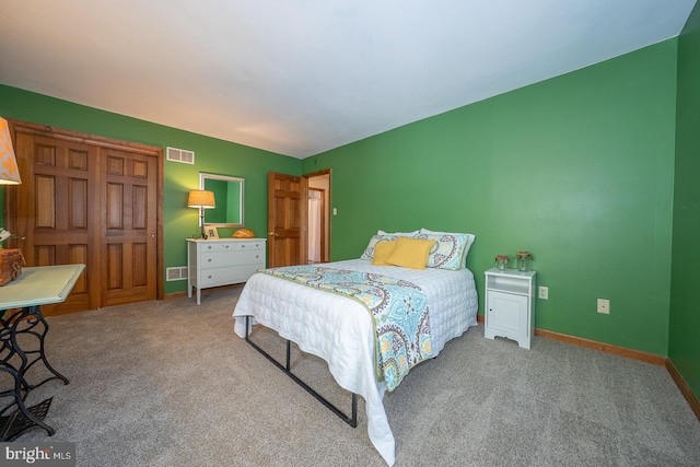 carpeted bedroom featuring visible vents and baseboards