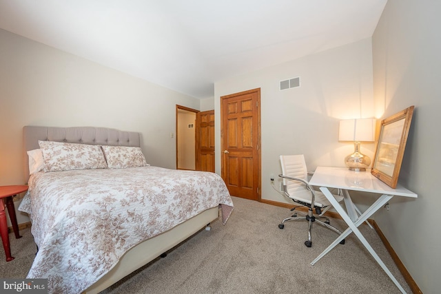 bedroom with baseboards, visible vents, and carpet