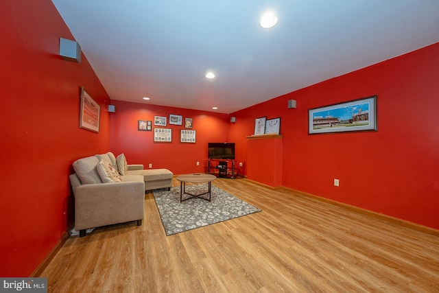 living area featuring recessed lighting, baseboards, and wood finished floors