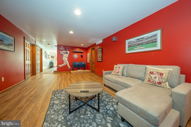 living area featuring recessed lighting, baseboards, and wood finished floors