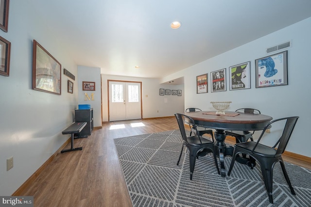 dining space with recessed lighting, baseboards, visible vents, and wood finished floors