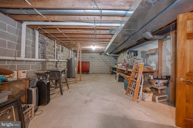 unfinished below grade area with water heater, a workshop area, and heating fuel