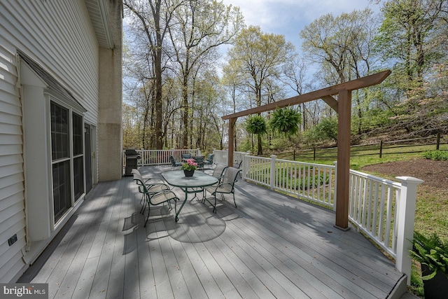 deck featuring area for grilling and outdoor dining area