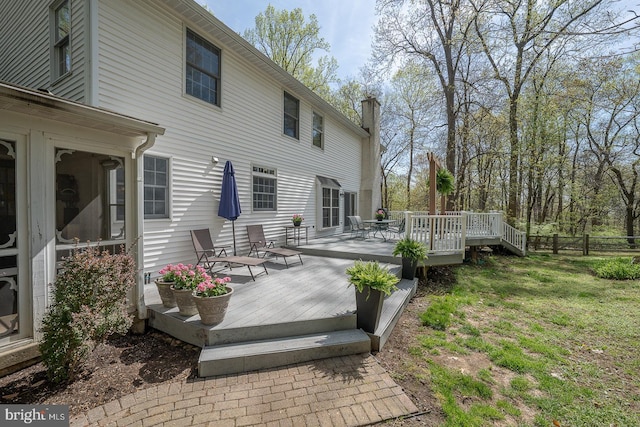 wooden deck with fence and outdoor dining area