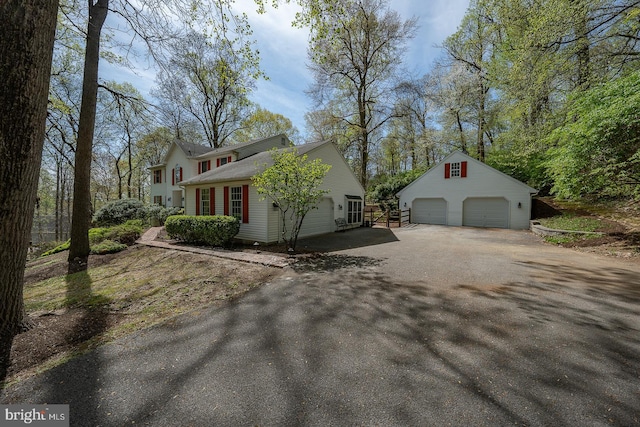 view of home's exterior with a garage and an outdoor structure