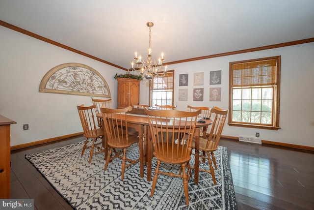dining area featuring visible vents, crown molding, an inviting chandelier, wood finished floors, and baseboards