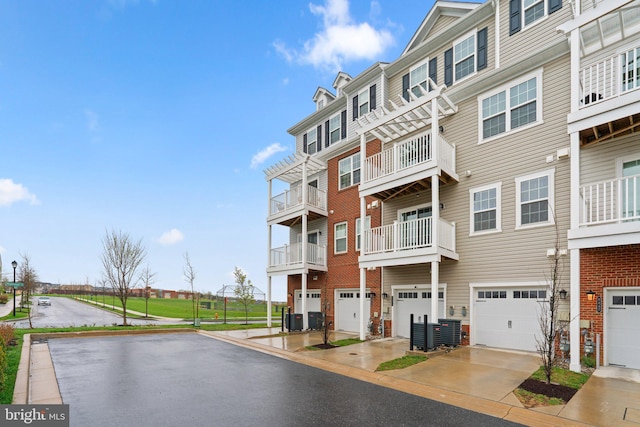 9451 James Macgowan Ln, Owings Mills, MD 21117 - view of building exterior featuring a garage, central AC unit, and driveway