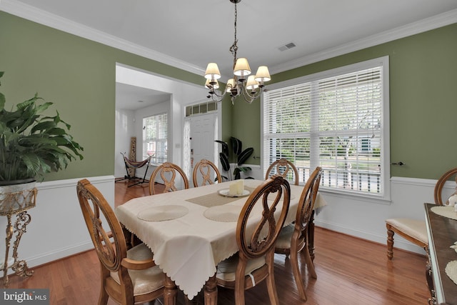2362 Sequoia Grove St, Waldorf, MD 20601 - dining area with visible vents, crown molding, wood finished floors, and a chandelier