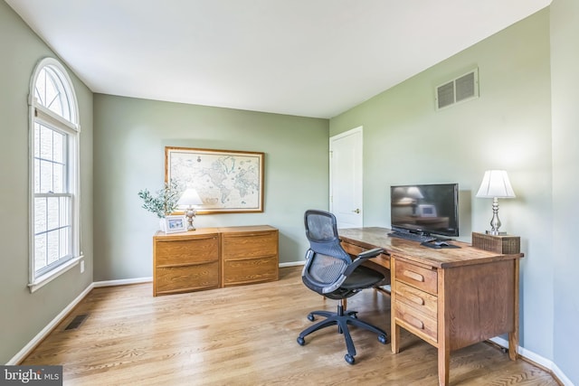 office area featuring wood finished floors, visible vents, and baseboards