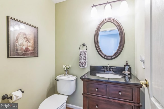 bathroom featuring toilet and vanity