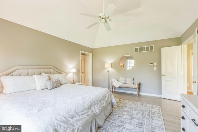 bedroom featuring light wood finished floors, baseboards, visible vents, a ceiling fan, and high vaulted ceiling