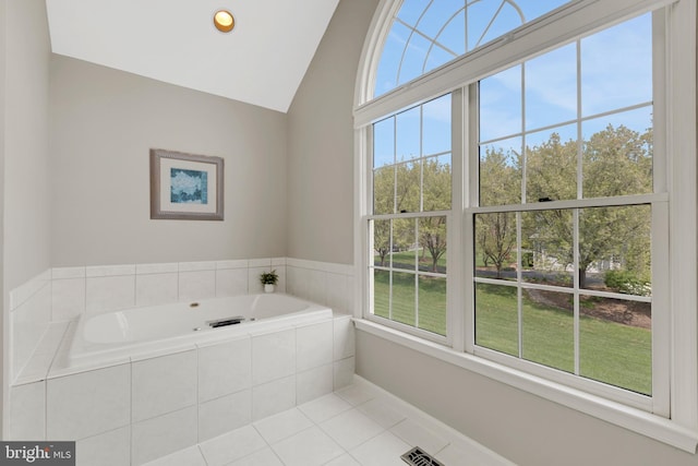 full bath featuring a garden tub, tile patterned flooring, vaulted ceiling, and baseboards