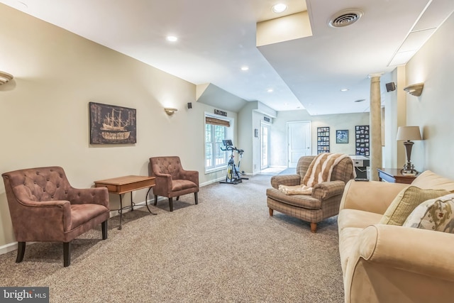 carpeted living area with recessed lighting, ornate columns, visible vents, and baseboards
