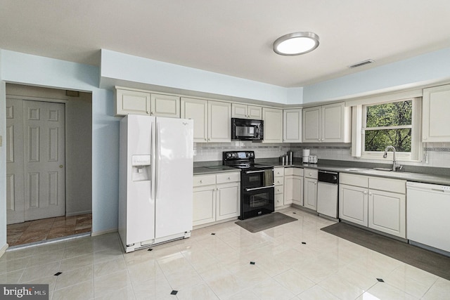 kitchen featuring backsplash, visible vents, a sink, black appliances, and light tile patterned flooring