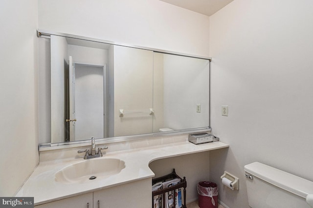 half bathroom featuring vanity and toilet