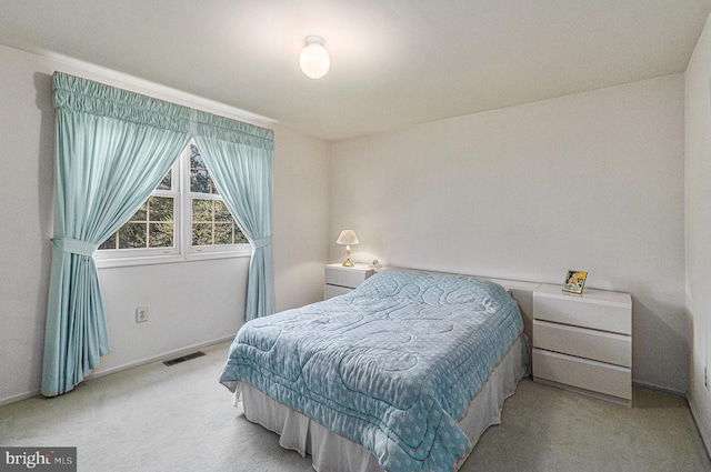 carpeted bedroom featuring visible vents and baseboards