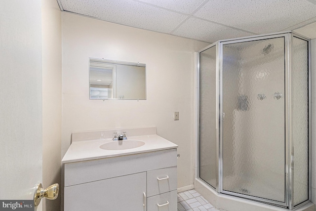 bathroom with vanity, tile patterned floors, a paneled ceiling, and a stall shower