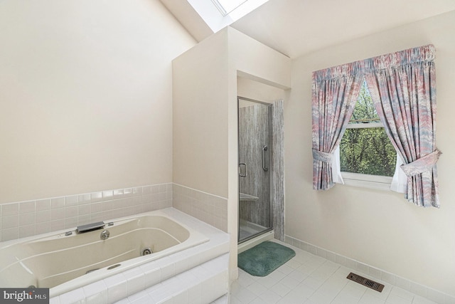 full bathroom with a tub with jets, a skylight, visible vents, and a shower stall