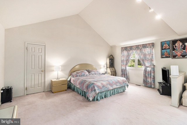 bedroom featuring carpet and high vaulted ceiling