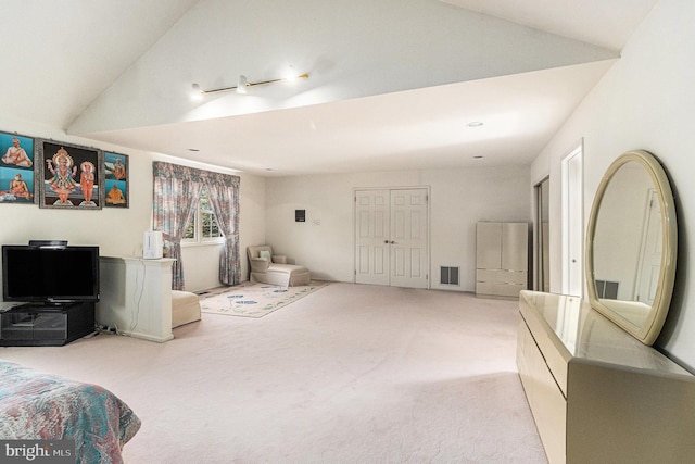 carpeted bedroom with vaulted ceiling and visible vents