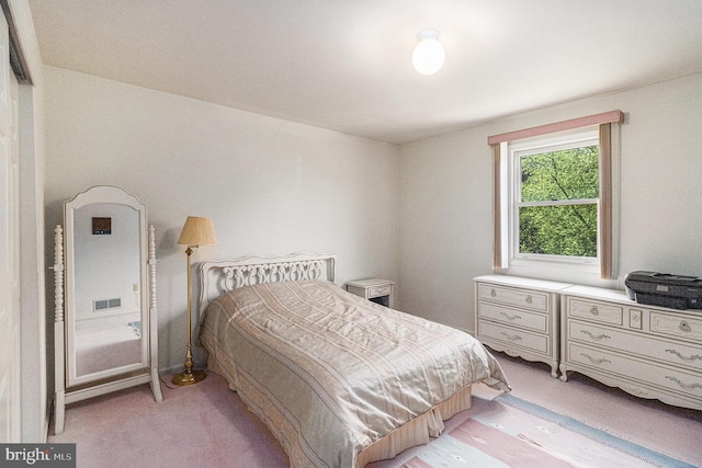 bedroom featuring visible vents and light carpet
