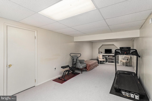 exercise room featuring baseboards, carpet, and a drop ceiling