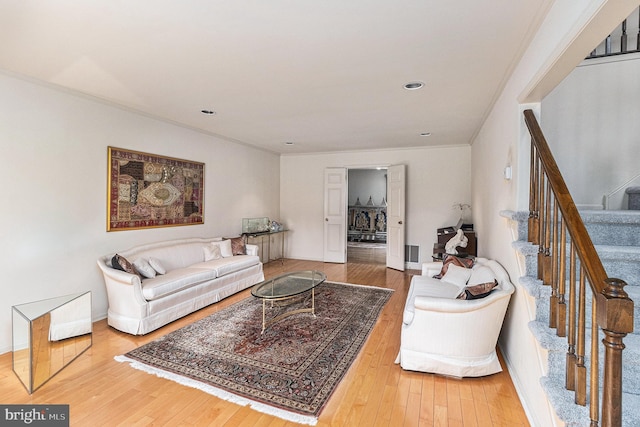 living area with recessed lighting, ornamental molding, stairway, and hardwood / wood-style flooring
