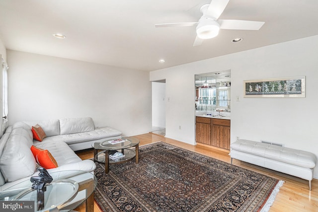 living room with recessed lighting, a ceiling fan, and light wood finished floors
