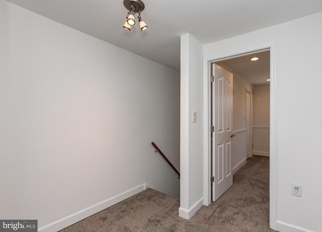 corridor featuring baseboards, carpet, recessed lighting, and an upstairs landing