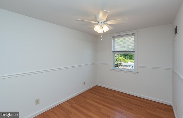 empty room featuring ceiling fan, baseboards, visible vents, and light wood-style flooring