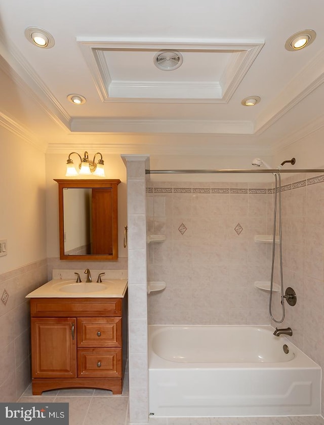 full bathroom with crown molding, tile walls, a raised ceiling, vanity, and tile patterned floors