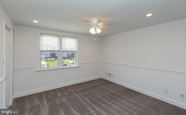 spare room featuring a ceiling fan, recessed lighting, dark carpet, and visible vents